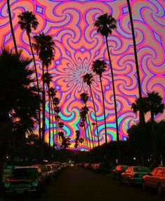 an image of palm trees in front of a psychedelicly colored sky with swirls