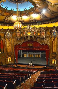 the interior of an old theater with red curtains