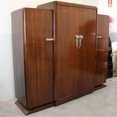 two wooden cabinets sitting next to each other