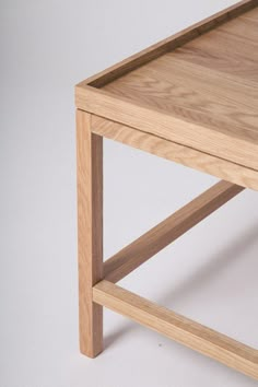 a close up of a wooden table on a white background with no one around it