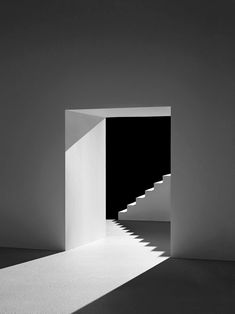 an empty room with stairs leading to the light