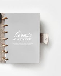 an open notebook with the words le genle with yourself written on it next to a watch