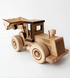 a wooden toy truck is shown on a white background