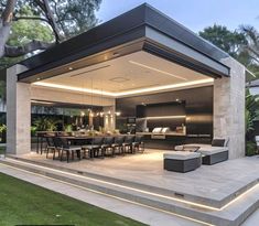 an outdoor dining area is lit up with lights and lighting from the ceiling to the floor