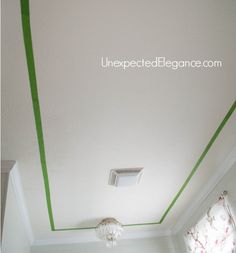 the ceiling is painted white and has green lines on it, as well as a light fixture