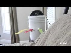 a white bucket sitting on top of a bed