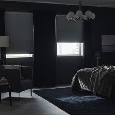 a bedroom with black walls and dark furniture