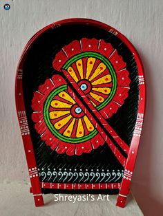 a red and black clock on a white wall with the words sheyasi's art written below it