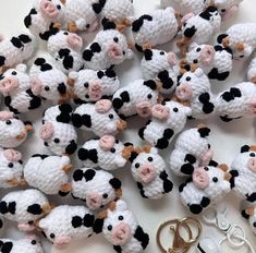 small crocheted cows with black and white faces are shown next to two pairs of scissors