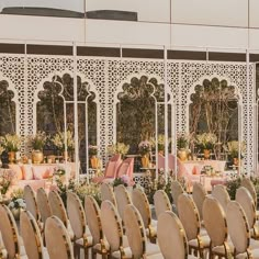 rows of chairs are lined up in front of an ornate wall