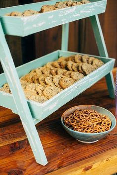 two tiered trays filled with cookies next to a bowl of oatmeal