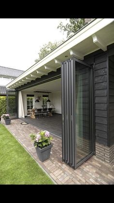 an open patio with potted plants on the side and sliding glass doors to the back