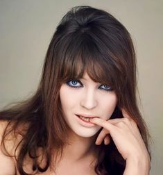 a woman with blue eyes posing for the camera