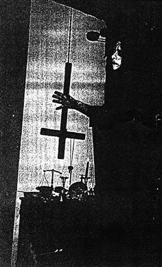 a black and white photo of a person holding a cross