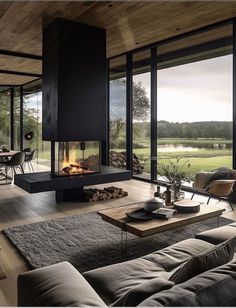 a living room filled with furniture and a fire place next to a large glass window