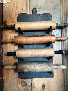 several wooden rolling wheels are hanging on the wall