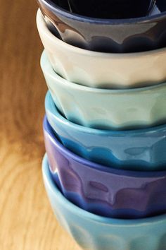 a stack of bowls sitting on top of a wooden table