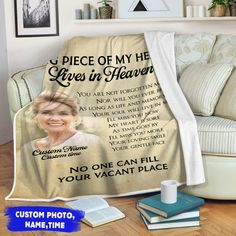 a couch with a blanket on it that says, i piece of my heart lives in heaven