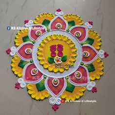 an intricate design on the floor with flowers and leaves in yellow, pink and green colors