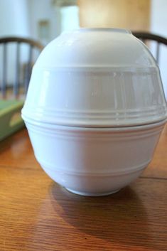 a white bowl sitting on top of a wooden table