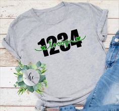 a t - shirt with the number twenty four on it, next to jeans and shoes