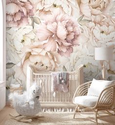 a baby crib in front of a floral wallpaper with pink flowers on it