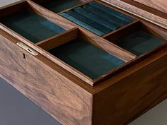 an open wooden box with several compartments in it