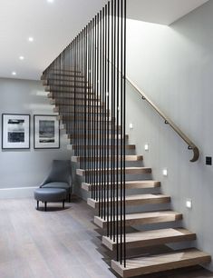 a staircase with wooden steps and metal handrails in a modern style living room