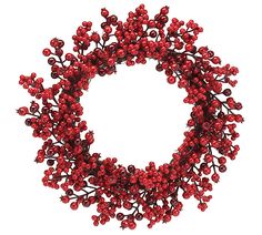 a wreath with red berries hanging from it