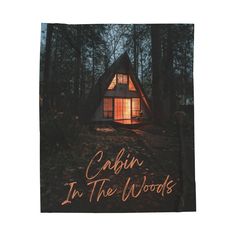 cabin in the woods lit up at night with text reading cabin in the woods written below