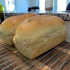 two loaves of bread cooling on a rack