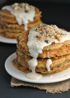 stack of pancakes covered in white icing and toppings