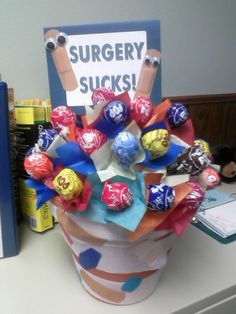 a vase filled with lots of candy sitting on top of a table