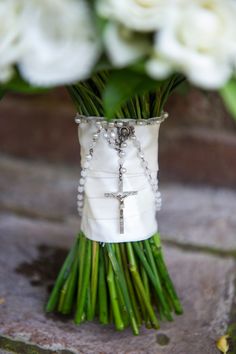 a bouquet of white flowers with a cross on it