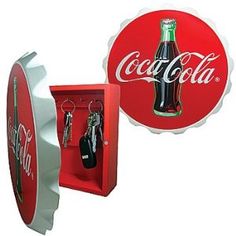 an open coca - cola bottle and keychain in a box