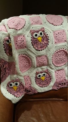 a crocheted owl blanket sitting on top of a couch