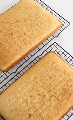 two pieces of cake sitting on top of a cooling rack next to another piece of bread