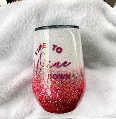 a wine glass that says time to wine now on it sitting on a white towel