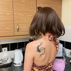 a woman with a fish tattoo on her back