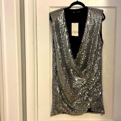 Silver Sequin Zara Party Dress In Size Medium Composition: 75% Polyester 25% Metallic Fabric Lining 100% Polyester Sleeveless Midi Dress For Holiday Night Out, Glamorous Sleeveless Midi Dress For Holiday Party, Dressy Sleeveless Sequin Dress For Party Season, Holiday Sleeveless Mini Dress, Sequined Dresses For Festival And Night Out, Chic Sleeveless Midi Dress For Holiday Party, Festive Sequin Midi Dress For Night Out, Festive V-neck Mini Dress For Party Season, Sleeveless Sequin Dress For Spring Formal