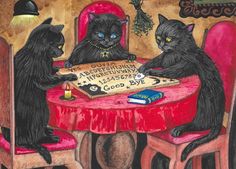 two black cats sitting at a table with a book