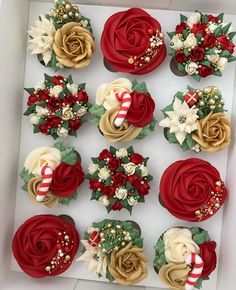 cupcakes decorated with flowers and candy canes in a box