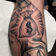 a man with a tattoo on his arm holding a money bag