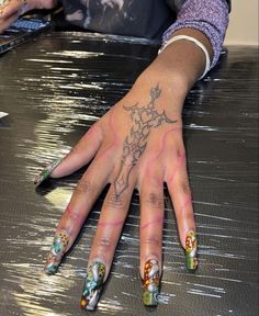 a woman's hand with colorful designs on it