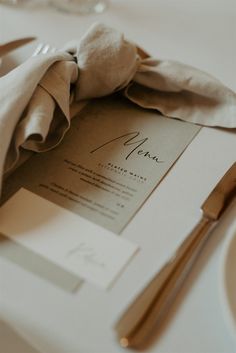 a table setting with napkins, silverware and utensils on the table