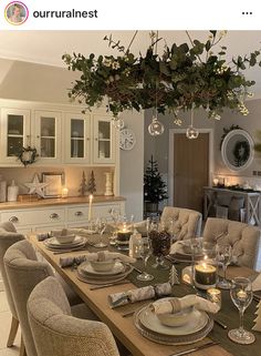 the dining room table is set with place settings for six people and has candles on it