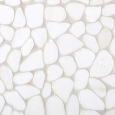 a close up view of a white stone wall with small rocks on it's surface