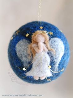 a blue ornament with an angel on it