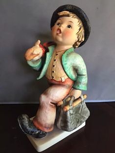 a figurine of a boy with a hat and boots