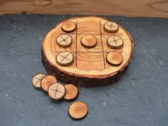 a wooden board game sitting on top of a blue floor next to pieces of wood